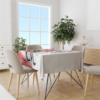 Red and white hockey-themed tablecloth draped over dining table with chairs