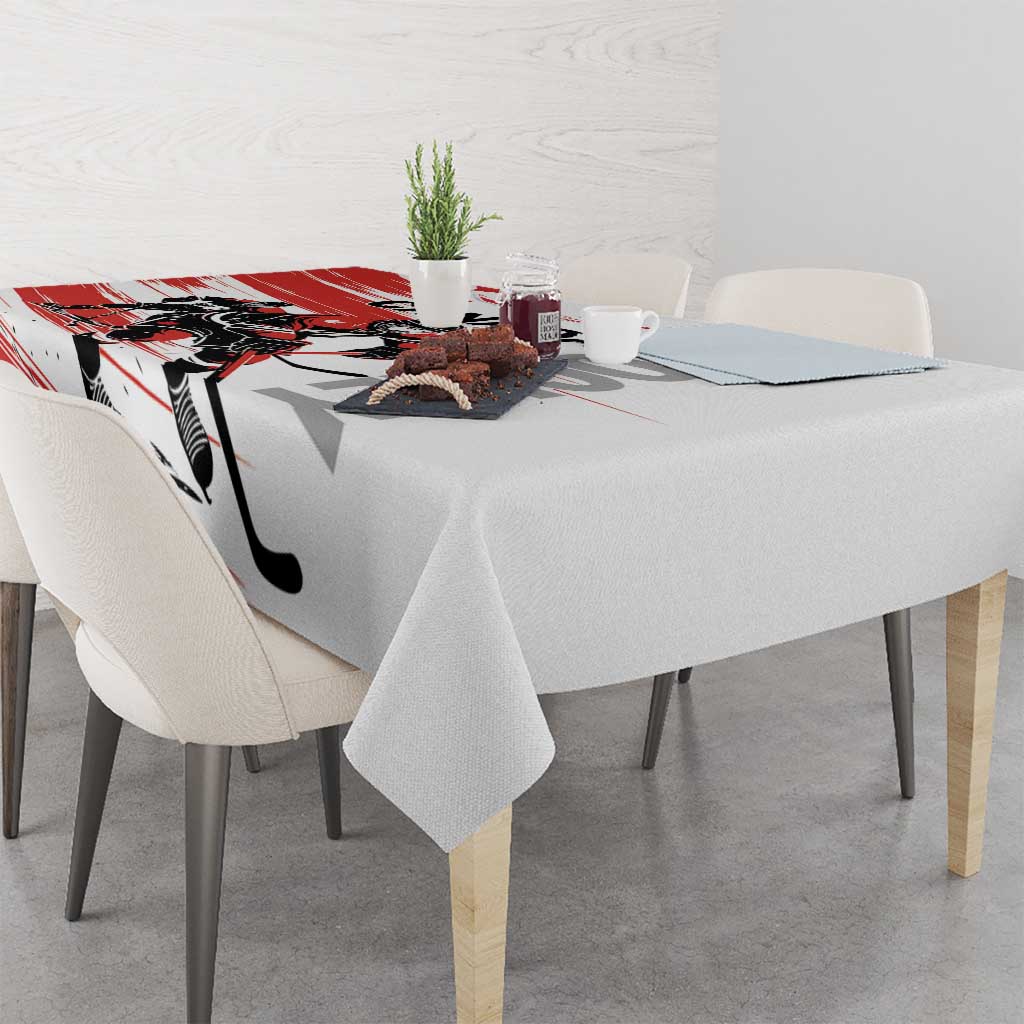 Red and white hockey-themed tablecloth on dining table with decorative items