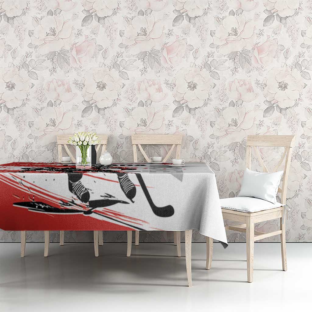 Red and white hockey-themed tablecloth on dining table with floral wall background