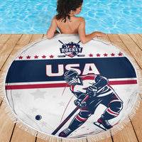 Round beach blanket with fringe, USA Hockey logo and USA player, red stripes across center