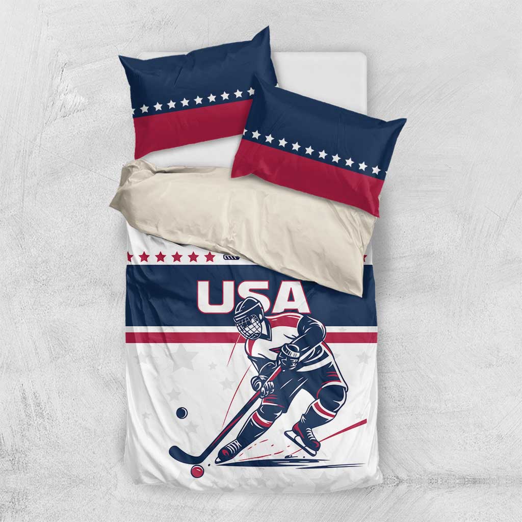 USA hockey bedding set laid flat: white duvet with blue panel and two red/blue pillows