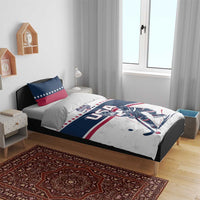 USA hockey bedding set in bedroom: white/blue duvet with player print and two star pillows