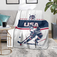 White and navy USA hockey blanket draped over sofa, hockey player and red-white stripe