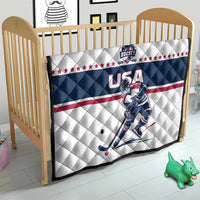 USA ice hockey quilt in a crib with navy center, red stripe, stars, and hockey player print