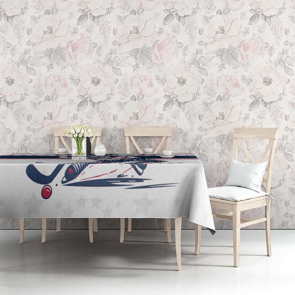 White ice hockey tablecloth covering dining table, navy/red border and USA hockey player graphic