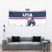 USA ice hockey tapestry over gray couch, with hockey player art, stars, and red white blue stripes