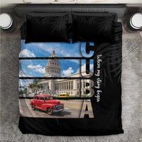 Black bedding set with printed blue sky scene, red car, and two black tropical-leaf pillows