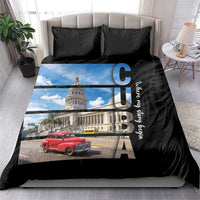 Black duvet cover set with blue-sky building print, red car, and two black patterned pillows