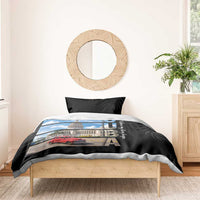 Black duvet cover set with blue-sky building and red car print, styled with two black pillows