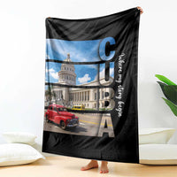 Black blanket with city landmark print, red car, and tall vertical letters; draped