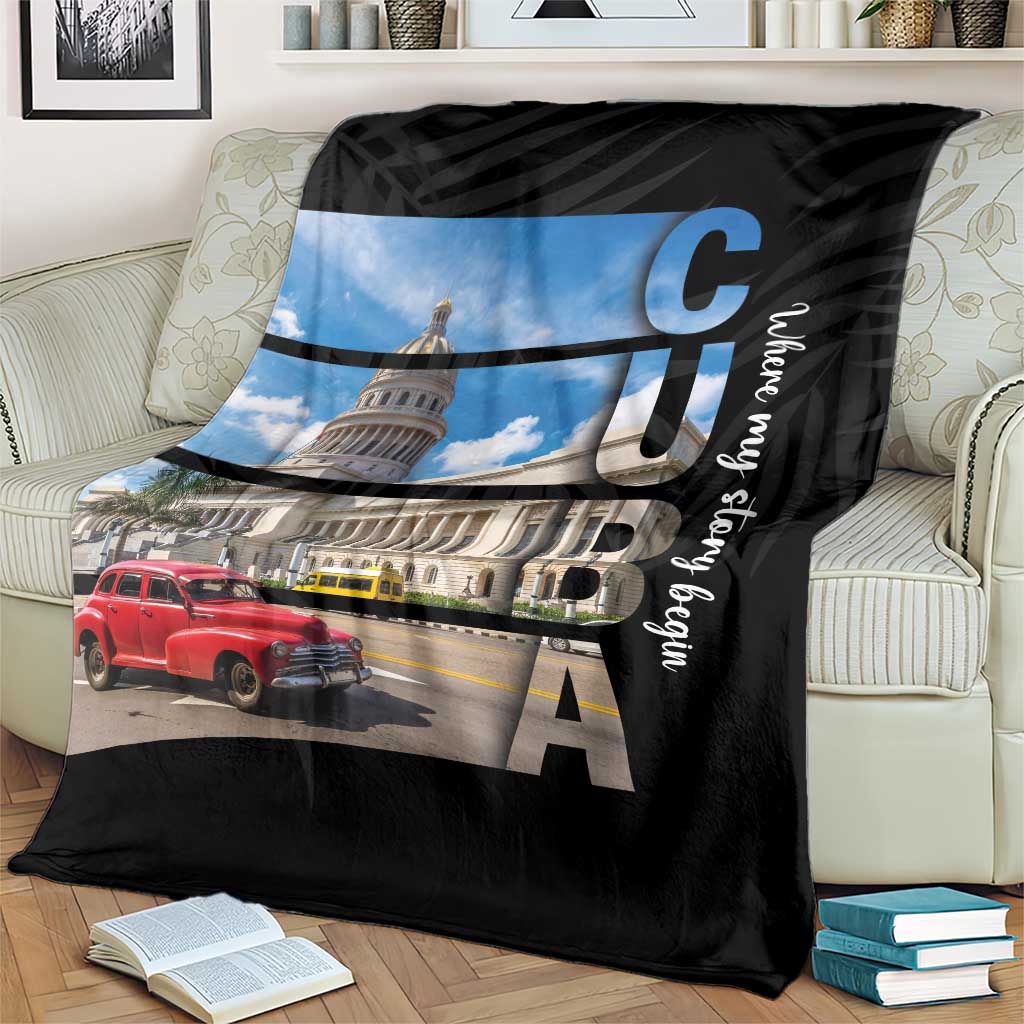 Black blanket with city landmark artwork, red car, and vertical cursive text detail
