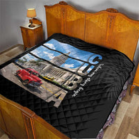 Black quilt on bed with diamond quilting and Cuba capitol print with red car