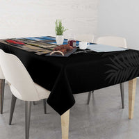 Black tablecloth draped on table with Cuba city print and palm leaf pattern
