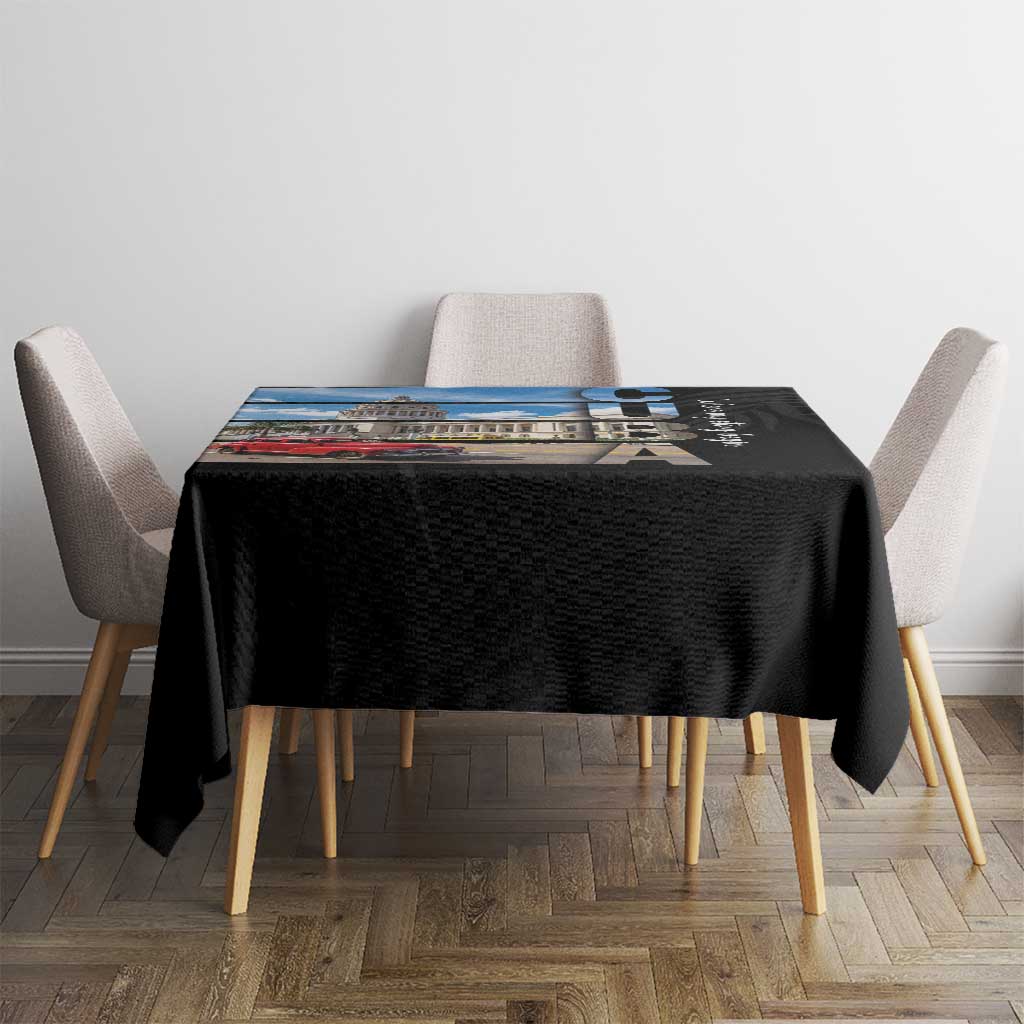 Black tablecloth with Cuba print across tabletop on a dining set with chairs