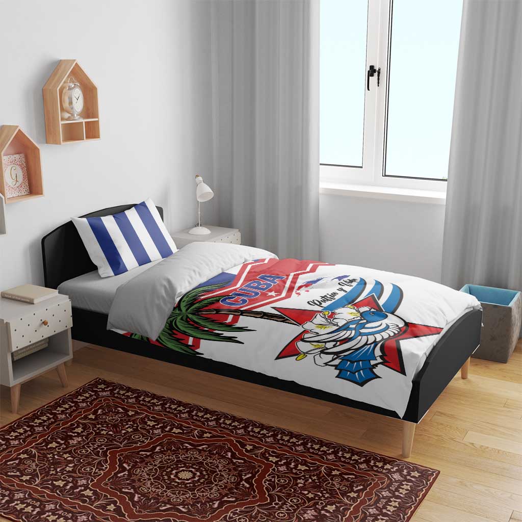 Cuba flag bedding set on bed with striped pillows and white duvet with colorful crest graphic