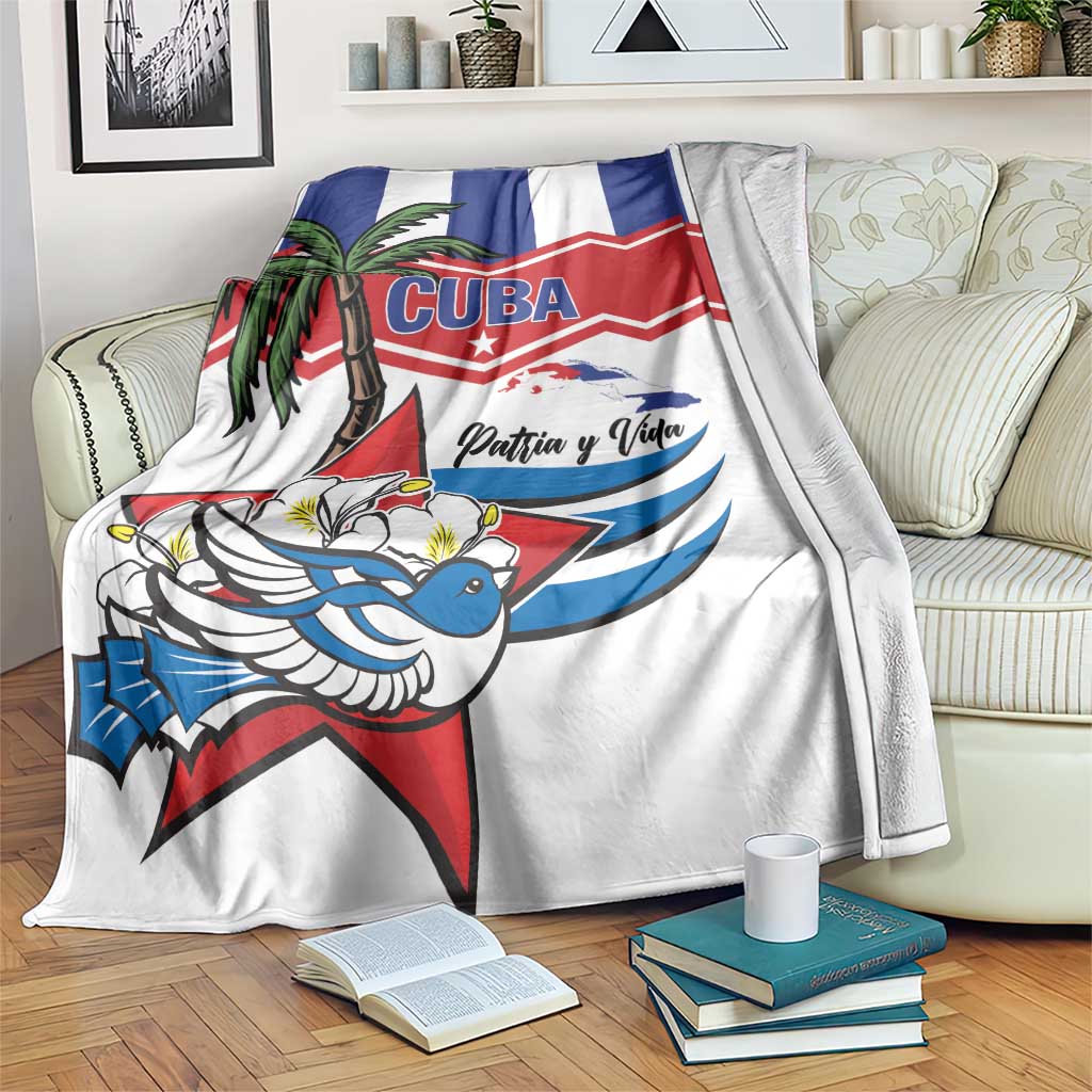 White Cuban-themed blanket with blue/red graphics, palm tree, bird, and “Patria y Vida”