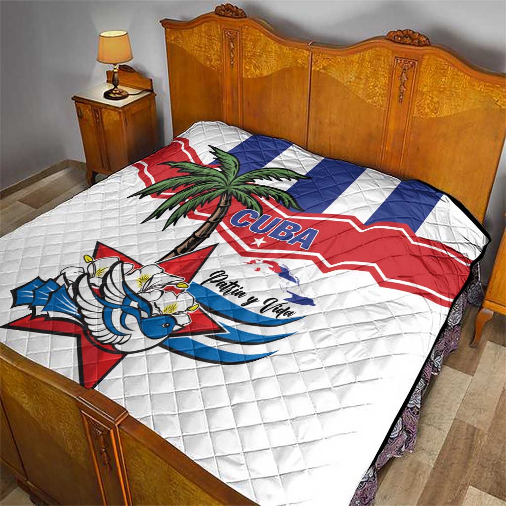 White quilt bedspread with Cuba flag zigzag, palm tree, and bird graphic in blue and red.