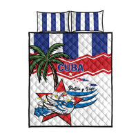 Quilt bed set with white quilt featuring Cuba emblem and quilted texture, plus blue striped pillows