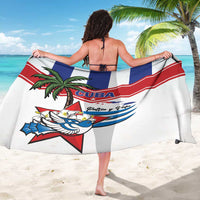 White Cuba-themed sarong draped around woman, showing palm tree and ribbon graphics