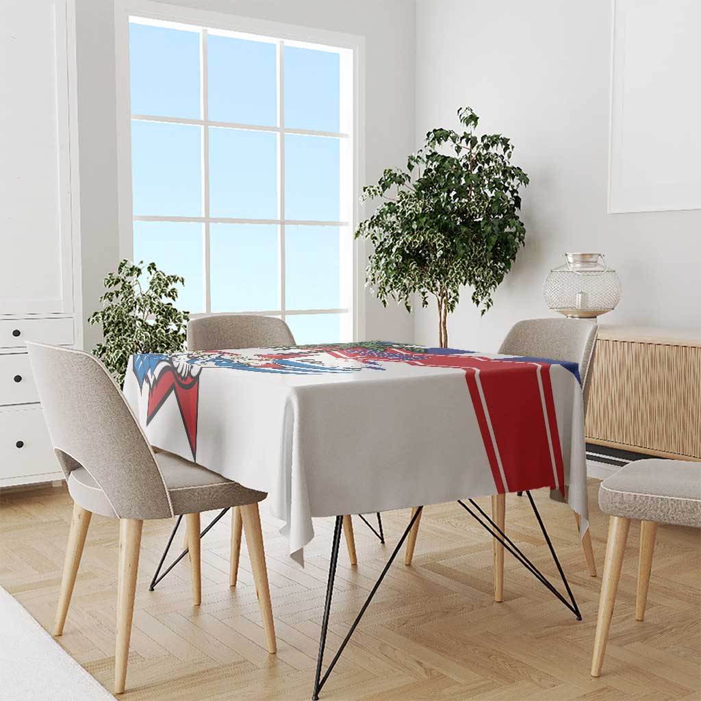 White tablecloth with red and blue stripe border and Cuban graphic on tabletop