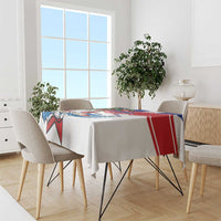 White tablecloth with red and blue stripe border and Cuban graphic on tabletop