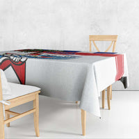 White tablecloth draped on table with bold red blue patterned band and bird graphic