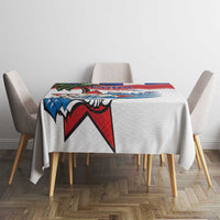 White tablecloth with colorful Cuban bird and red blue star motif centered