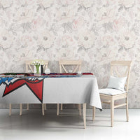 White tablecloth with red blue bird graphic stripe running along the top edge