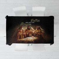 Black tablecloth with printed Three Kings Day nativity scene and gold text