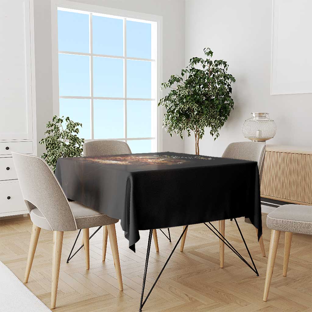 Black tablecloth draped over rectangular dining table with even overhang