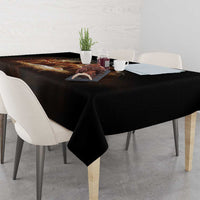 Black tablecloth covering dining table with folded corner and smooth drape