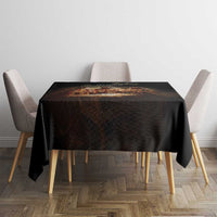 Black tablecloth covering square dining table with four chairs around it