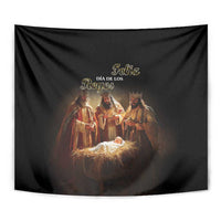Black tapestry close-up of three kings over baby Jesus in glowing manger
