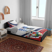 White bedding set on bed with blue-red stripe and Panama shield print, Dia de los Martires