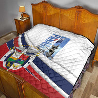 Panama Martyrs Day quilt on wooden bed, white top with blue and red stripes