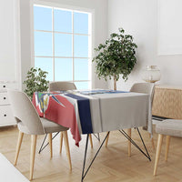 Printed tablecloth in white with blue and red flag design over a dining table