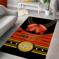 Black and orange area rug with bow and 'CINCO de Mayo' lettering, gold border patterns, emblem
