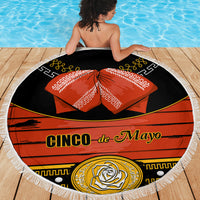 Fringed round beach blanket with black base and red Cinco de Mayo design