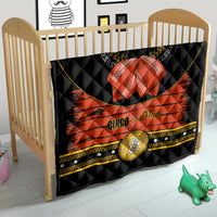Charro quilt in nursery crib, black and orange quilted design with red bow and gold emblem