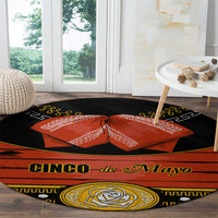 Black round carpet rug with 'Cinco de Mayo' text, orange bow, and gold rose medallion