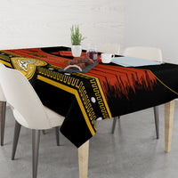 Black Cinco de Mayo tablecloth with gold geometric trim and red rays across tabletop