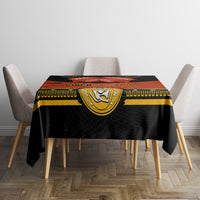 Black tablecloth with gold emblem panel and red banner style print across center