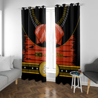 Black window curtains with red sombrero print and gold accents centered on a window