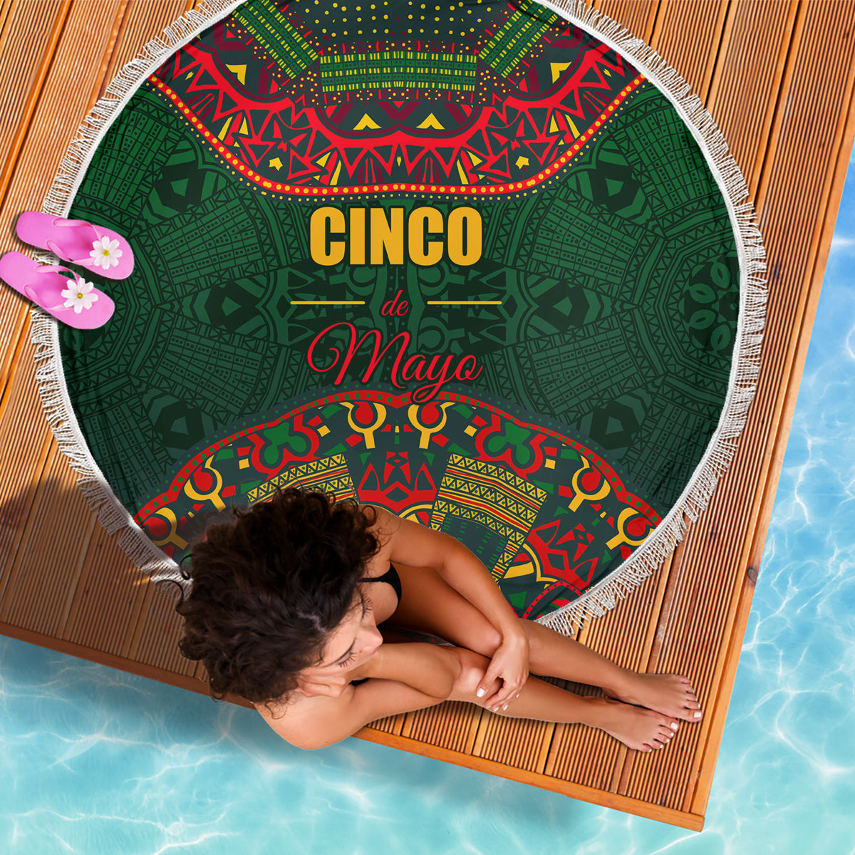 Green round beach blanket with white fringe edge and Cinco de Mayo folk pattern design