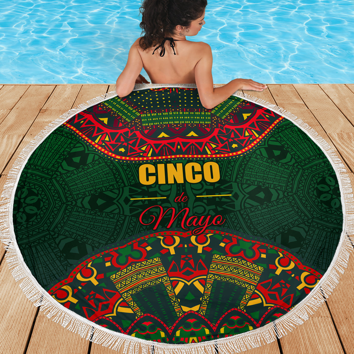 Green round beach blanket with white fringe and Cinco de Mayo folk pattern
