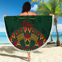 Green round beach blanket with white fringe, Cinco de Mayo folk pattern, held up