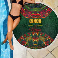 Green round beach blanket with white fringe, Cinco de Mayo folk pattern, draped