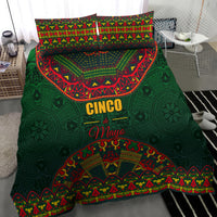 Green bedding set close view with colorful folk design comforter and two pillowcases.