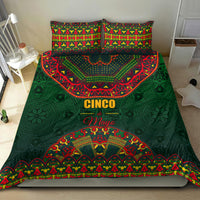 Green bedding set on bed featuring bold Cinco and decorative folk arch pattern.