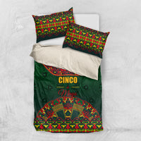 Green bedding set laid on white background: comforter plus two decorative pillowcases.